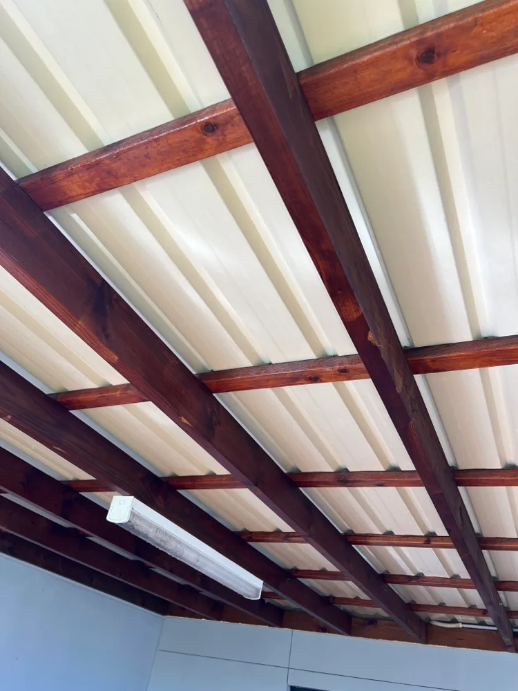 Cleaned timber-beamed pergola ceiling
